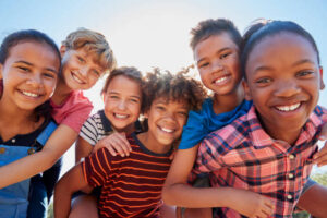 Kids smiling, feeling safe and happy, symbolizing healing and progress after trauma.