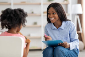 A therapist and a girl having a conversation in a cozy, calm space.