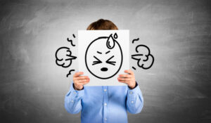 Child using art and play tools to communicate feelings in therapy