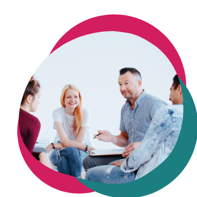 Photo of multiple people sitting in a circle talking. Looking for new ways to find support? Learn how group therapy in Macon, GA can help you manage your mental health.