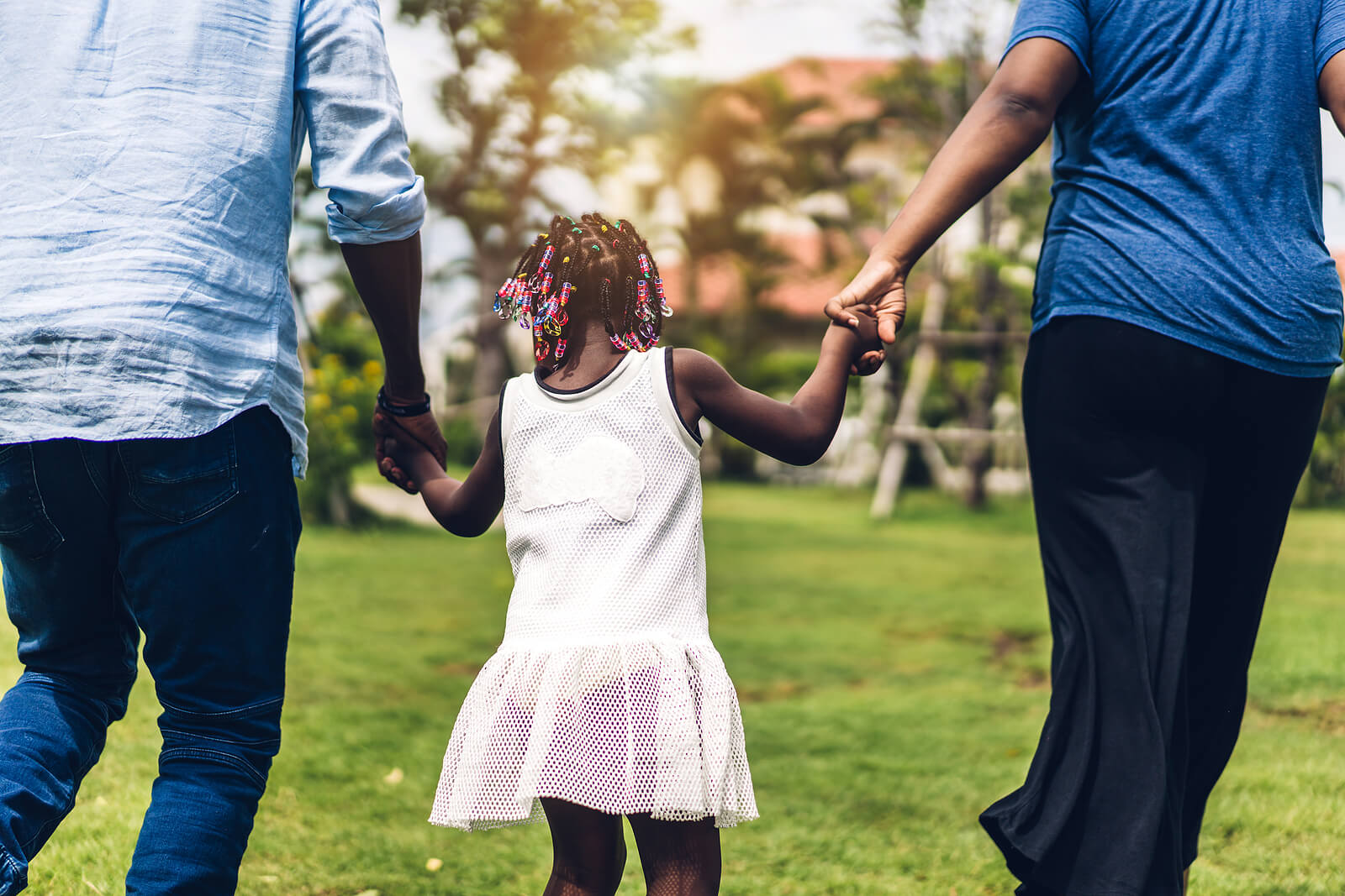 Photo of an African American family walking outside and holding hands. Looking for a convenient way to start managing your mental health? Discover how easy it is to access therapy in Hiram, GA soon!