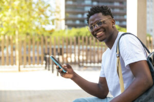 Photo of a smiling teen African American boy smiling outside. Is your teen struggling to manage their mental health? Discover how therapy in Hiram, GA can help your teen begin coping in a healthy way.