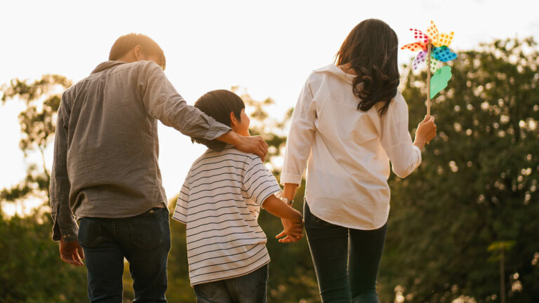 Photo of a happy family walking with each other outside. Are you or someone in your family struggling with trauma, grief, or stress? With EMDR therapy for children in Macon, GA you and your family can begin overcoming your symptoms with support from a therapist.