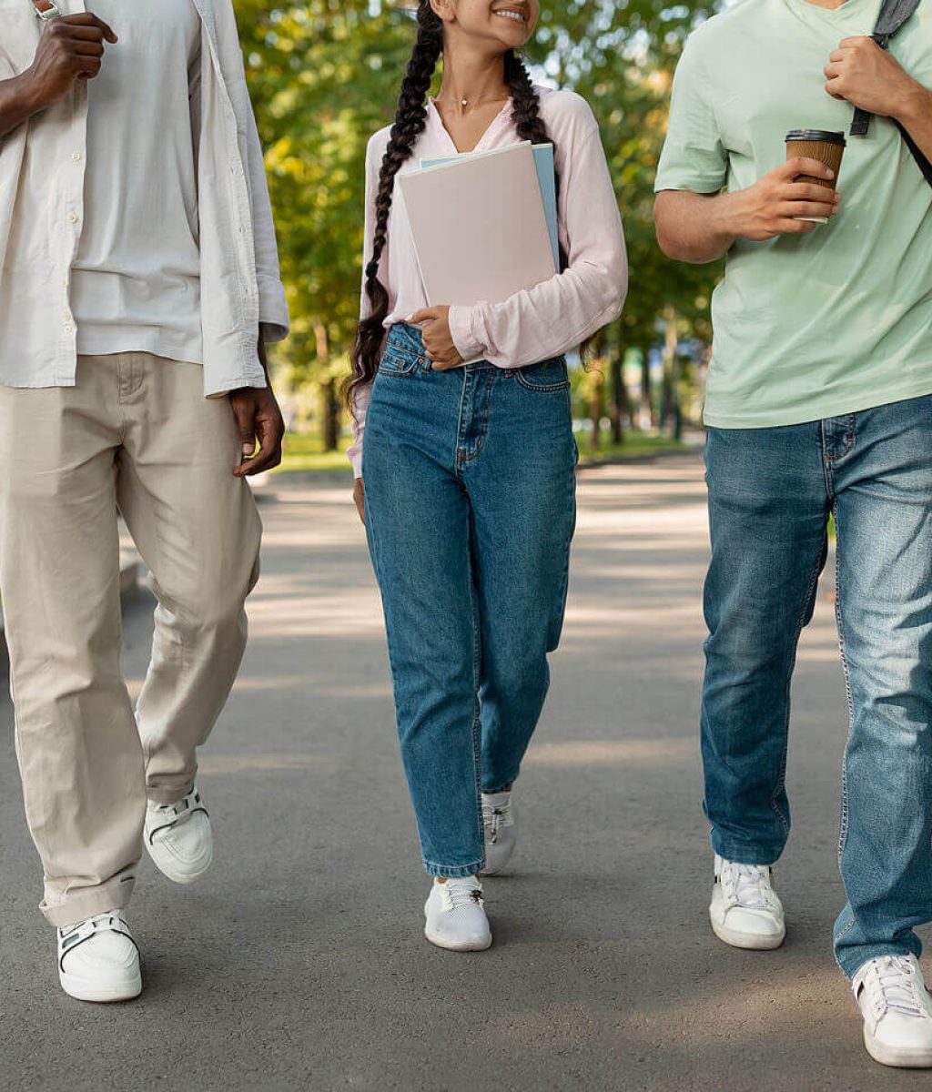 Photo of a two young adult males and one young adult female walking and smiling carrying their backpacks. Struggling with the new transition of being on your own for the first time? Discover how a skilled therapist can help you begin to overcome your anxiety with therapy for young adults in Macon, GA.