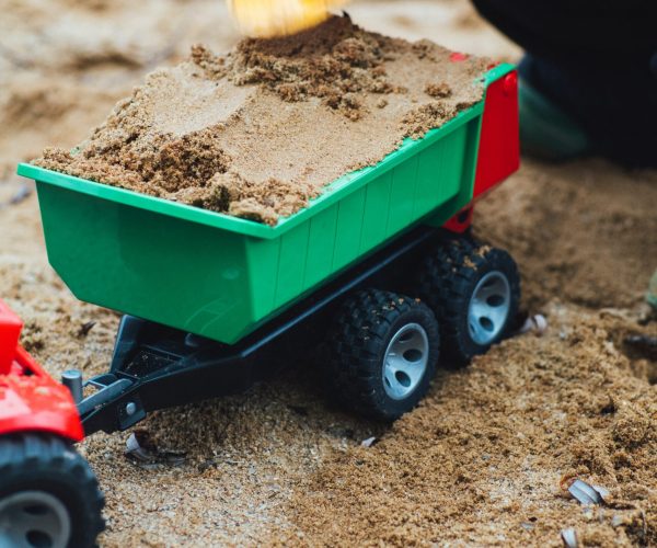 Photo of a child's dump truck toy in sand. Is your child struggling with anxiety or depression? Discover how play therapy in Macon, GA can help provide them with support in managing their symptoms.