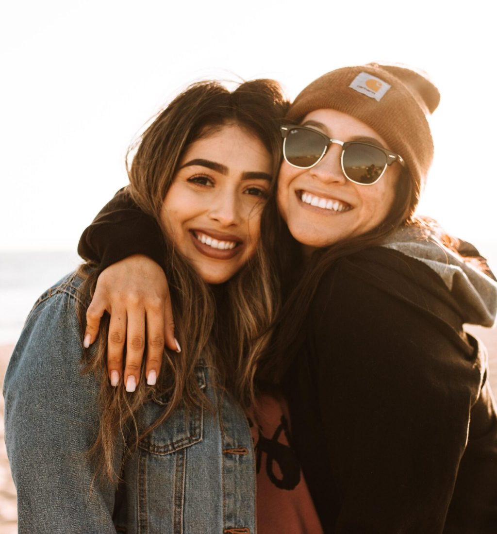 Photo of two young adult women hugging each other and smiling. Are you struggling with life transitions that are affecting your life? With therapy for young adults in Macon, GA you can begin managing your big changes in a healthy way.