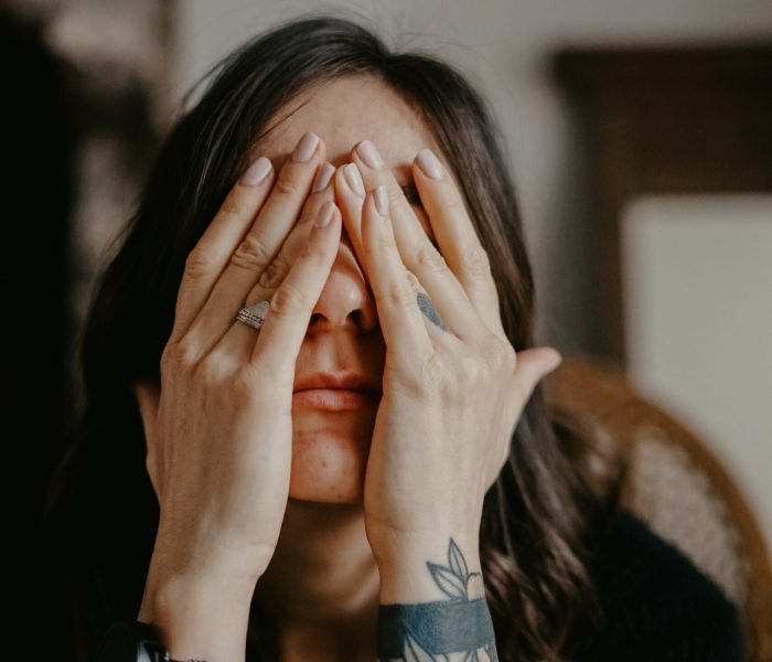 Photo of an upset woman covering her face with her hands. Do you struggle with depression? Learn how depression counseling in Macon, GA can help you cope with your symptoms in a healthy way.