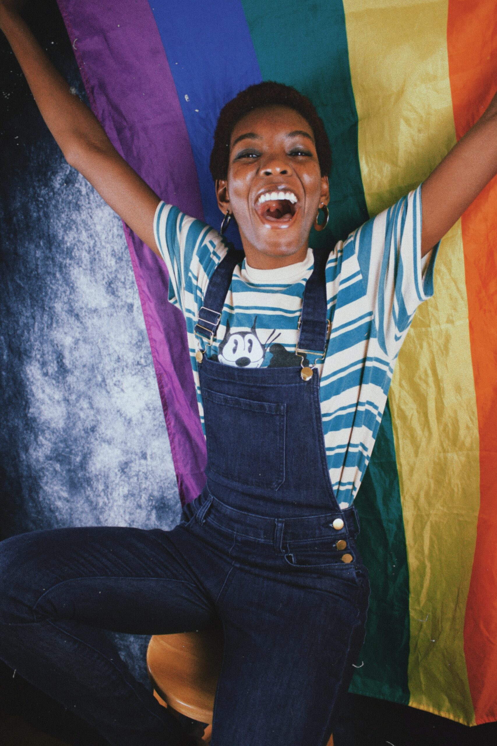 Photo of an African American woman holding up a rainbow flag representing the LGBTQ+ community. Are you a member of the LGBTQ+ community and struggle with your feelings? Learn how LGBTQ affirming therapy in Macon, GA can help you manage your emotions in a healthy way.