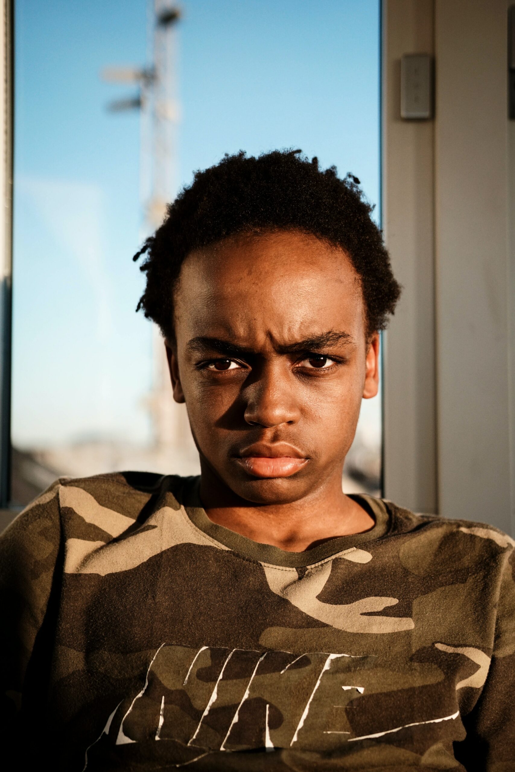 Photo of a young African American child displaying an angry face. Learn to break free from your anger issues with the help of anger management counseling in Macon, GA.
