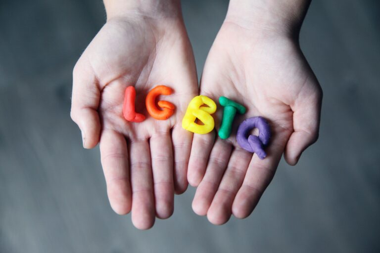 Photo of someone holding the letters lgbtq out of rainbow clay. Is your child or teen looking to find their identity as an LGBTQ member? Learn how therapy for LGBTQ youth in Macon, GA can help support your child.