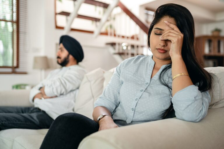 Photo of an upset couple sitting apart on a couch. Are you and your partner struggling to manage conflict? Discover how couples therapy in Macon, GA can help you and your partner begin finding conflict resolutions.