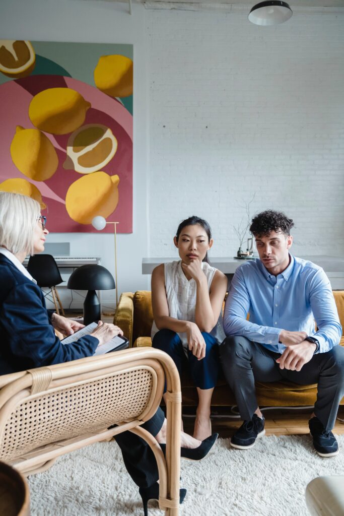 Photo of a couple sitting with a couples therapist looking upset. If you and your partner have a difficult time trying to overcome the struggles in your relationship, learn how couples therapy in Macon, GA can help you.