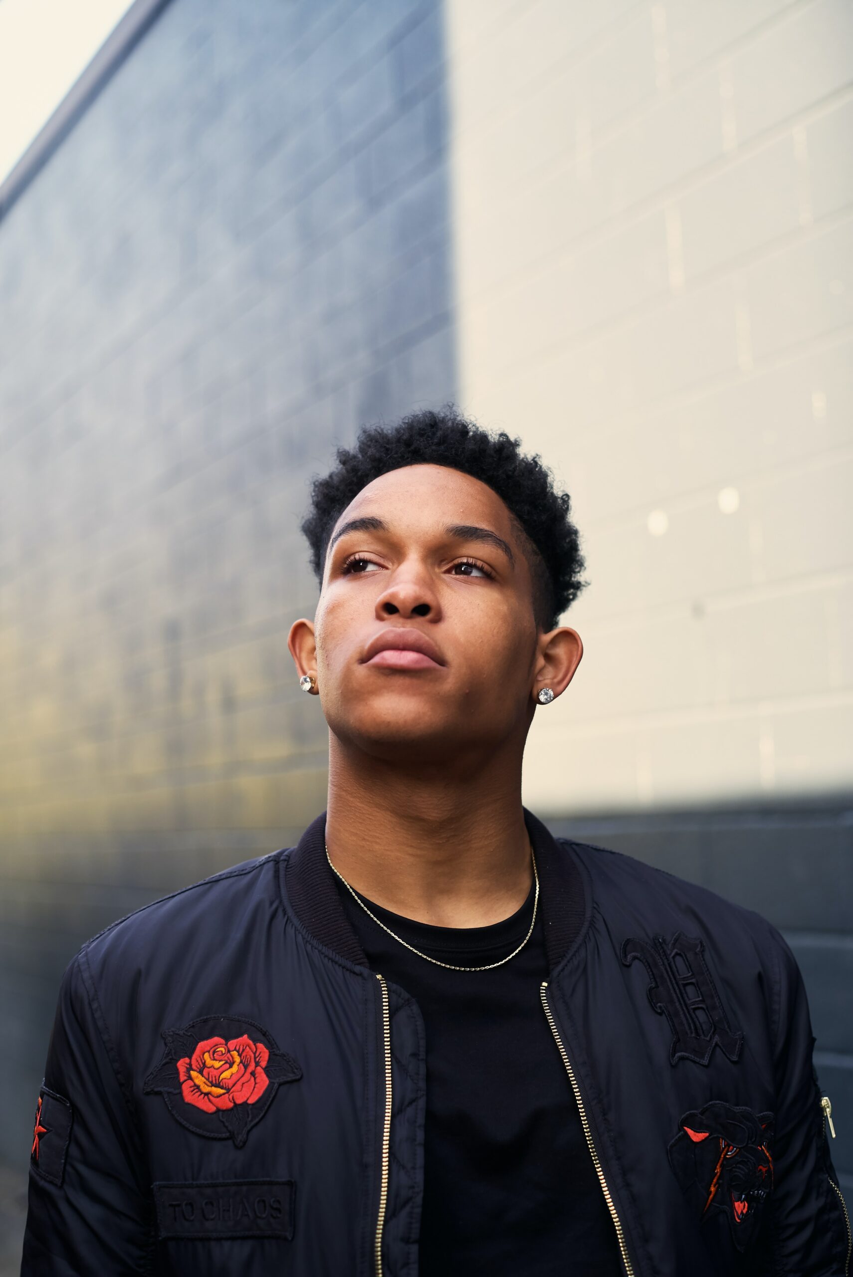 Photo of an African American man standing outside looking away from the camera. Are you struggling with trauma symtpoms? Discover how brainspotting in Macon, GA can help you begin working to overcome your symptoms.